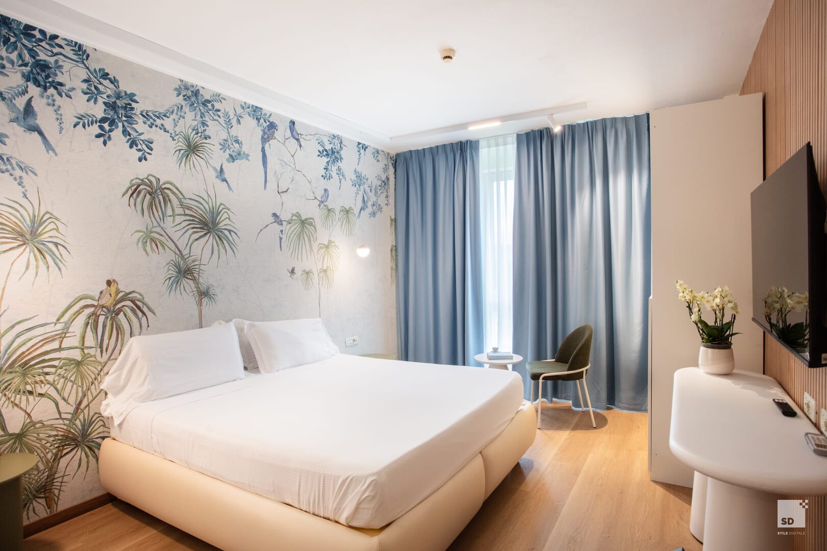Camera d'albergo moderna con letto matrimoniale e decorazioni.